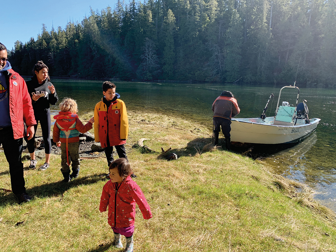 Members of Tla-o-qui-aht First Nation gather at Tsisakis (aka heel boom bay) on Meares Island in 2019 for the 35th Anniversary of the peaceful blockades that took place there in 1984 which established Meares Island as a Tribal Park. Credit: Eli Enns.