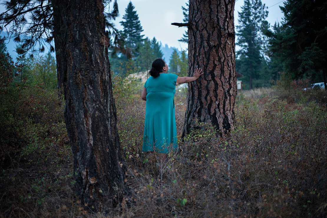 A woman carries out an offering ceremony at the Tiny House Warriors' camp. The Tiny House Warriors are a group of activists who constructed a series of homes in the path of the Trans Mountain oil sands pipeline development. Credit: Ian Willims.